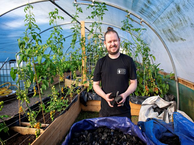 Sean Kerr of Sustainable Thinking Scotland, in a polytunnel with plants